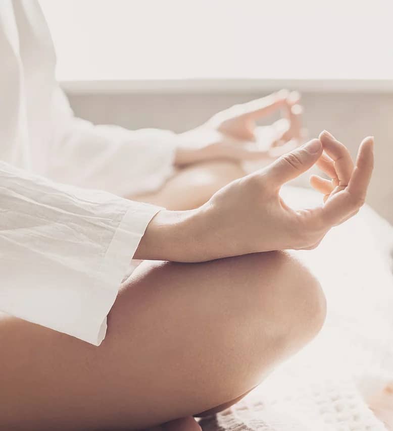 Person meditating on floor