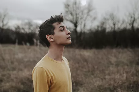 Guy outdoors with his chin up